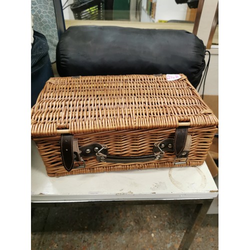 214B - WICKER HAMPER WITH A LOVELY RED TABLE RUNNER AND A SLEEPING BAG