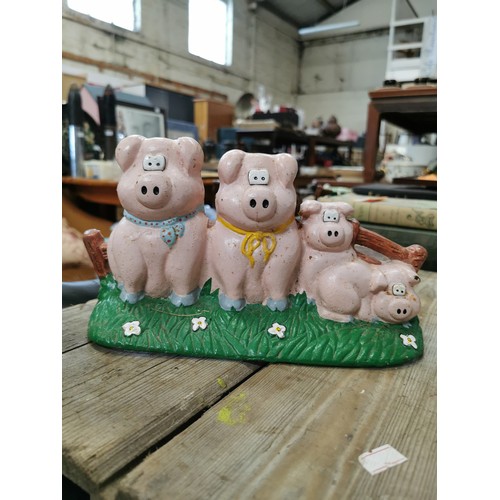 209A - CAST IRON DOORSTOP FEATURING 4 PIGS