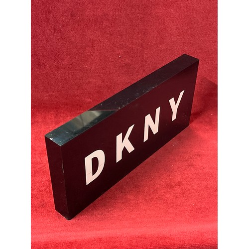 76 - DKNY ADVERTISING PLAQUE IN BLACK AND WHITE