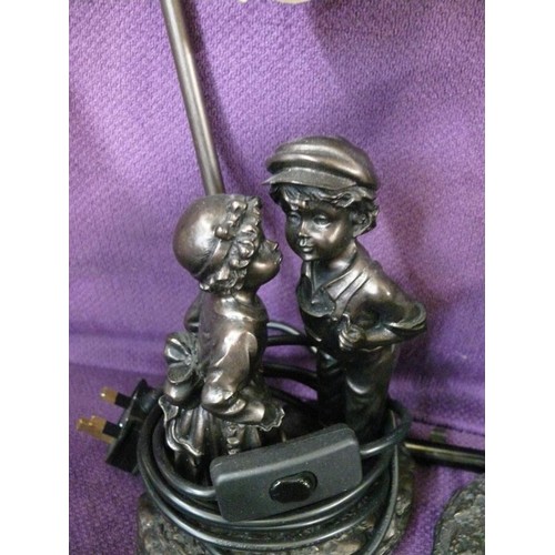 117 - CHILDREN KISSING TABLE LAMP WITH GLASS SHADE PLUS A FIGURE OF CHILDREN PLAYING LEAPFROG