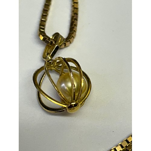 31 - A 9ct GOLD LONG CHAIN 24 INCHES AND PENDANT REAL SOUTH SEA PEARL IN A CAGE WEIGHT 9gr