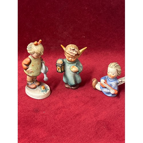 7 - 3 GOEBEL HUMMEL WEST GERMANY FIGURES - GIRL WITH WATERING CAN, ANGEL WITH LANTERN AND ANGEL WITH MUS... 