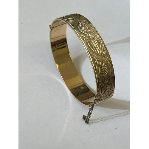 52 - A LOVELY BANGLE GOLD PLATED WITH CARVED PATTERN