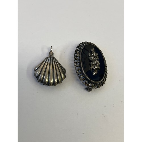 33C - A MOURNING BROOCH WITH JET STONE AND MARCASITE PLUS A SILVER FOB SHELL