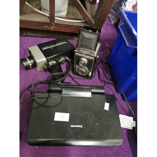 140 - HALINA SUPER CINE CAMERA, REFLECTA LENSE AND A PANASONIC CAR DVD PLAYER