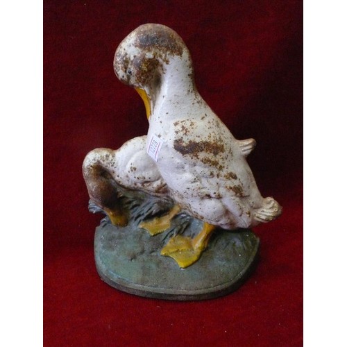 98 - A SMALL VINTAGE METAL SHELF PLUS A CAST IRON GOOSE DOORSTOP