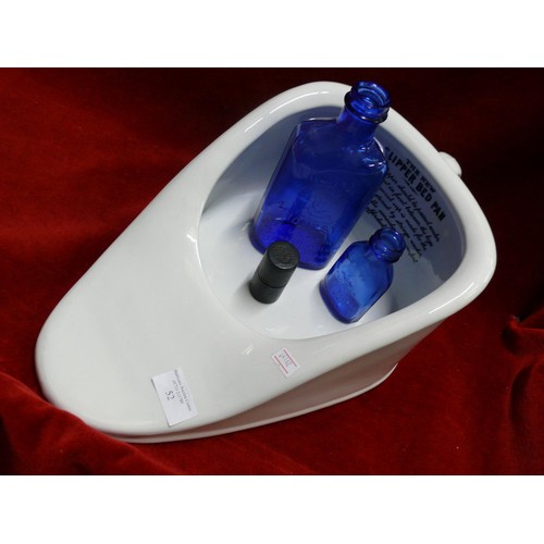 52 - SLIPPER BED PAN TOGETHER WITH TWO MILK OF MAGNESIA BLUE BOTTLES & AN ANTIQUE MINIM MEASURE IN LEATHE... 