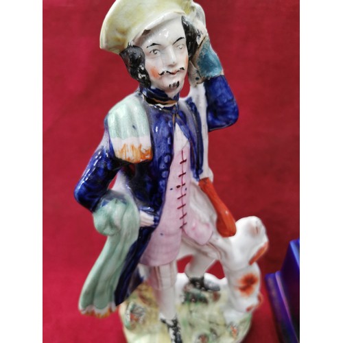 153 - Victorian Staffordshire pottery figure of a huntsman with a dog, glued damage to the head and hand. ... 