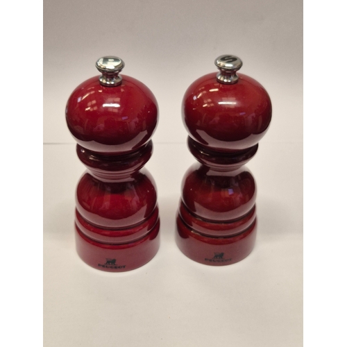 53 - A PAIR OF PEUGEOT SALT AND PEPPER GRINDERS IN RED