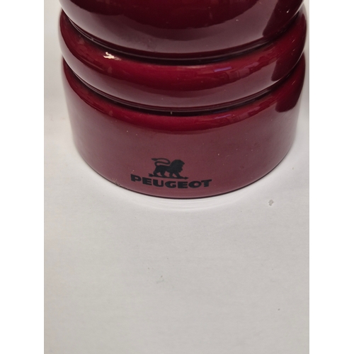 53 - A PAIR OF PEUGEOT SALT AND PEPPER GRINDERS IN RED