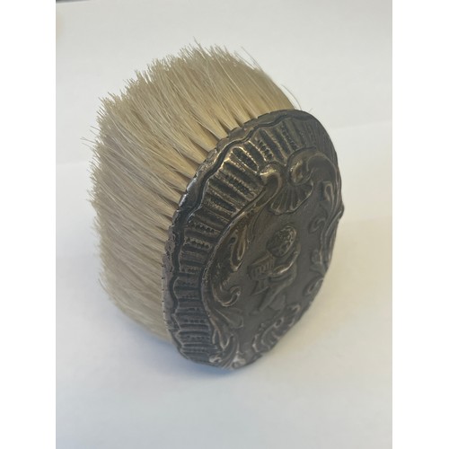 23 - A VICTORIAN SILVER CLOTHES BRUSH WITH A CHERUB WITH WINE GLASS