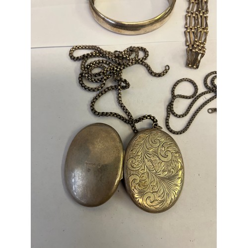 31 - A SILVER COLLECTION CONSISTING OF  1 OUNCE INGOT,  A LARGE LOCKET AND CHAIN,  A BANGLE BRACELET AND ... 