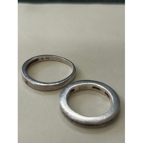 23 - 2 MODERN STYLE STERLING SILVER RINGS, ONE SET WITH SMALL DIAMOND (TESTS) THE OTHER AN ETERNITY RING ... 