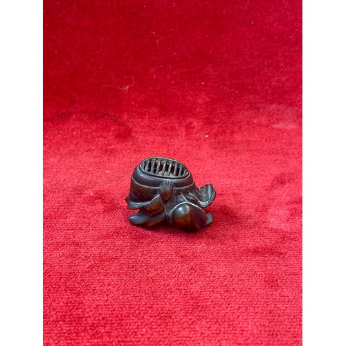 47 - Japanese boxwood Netsuke, finely carved in the form of a small figure crouching beneath a larger bōg... 