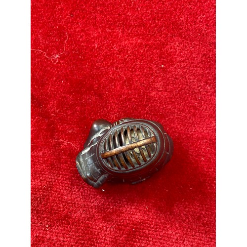 47 - Japanese boxwood Netsuke, finely carved in the form of a small figure crouching beneath a larger bōg... 