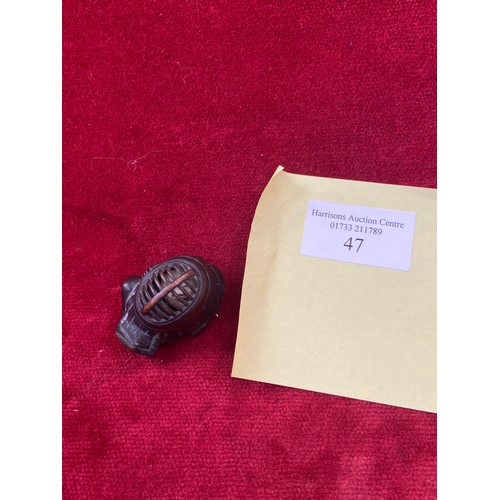 47 - Japanese boxwood Netsuke, finely carved in the form of a small figure crouching beneath a larger bōg... 