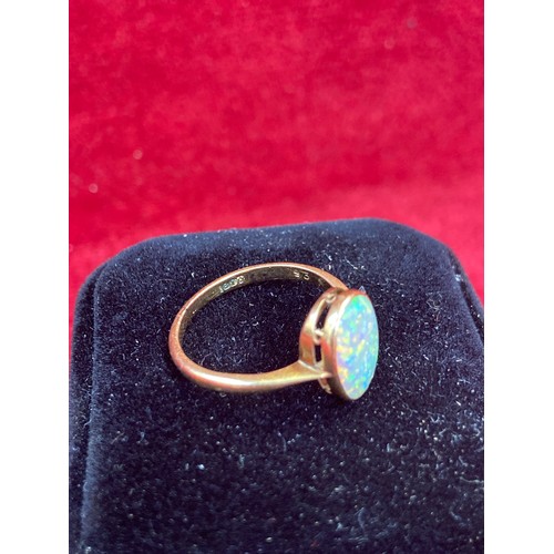 63 - A Vintage 18ct gold ring set with a good sized opal cabochon (12mm x 8mm). Good depth of colour. Siz... 