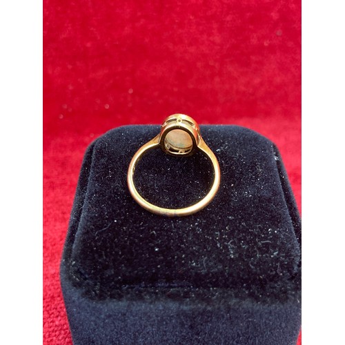 63 - A Vintage 18ct gold ring set with a good sized opal cabochon (12mm x 8mm). Good depth of colour. Siz... 