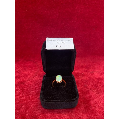 63 - A Vintage 18ct gold ring set with a good sized opal cabochon (12mm x 8mm). Good depth of colour. Siz... 