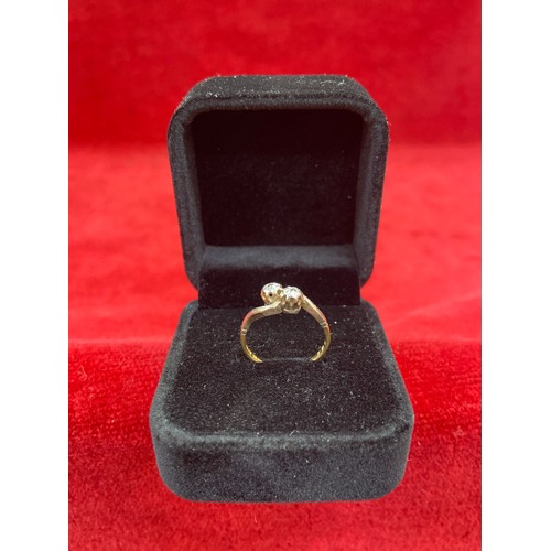 64 - A Vintage 18ct gold ring in crossover design platinum setting with two diamonds. Size L 2.2 grams