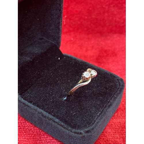 64 - A Vintage 18ct gold ring in crossover design platinum setting with two diamonds. Size L 2.2 grams