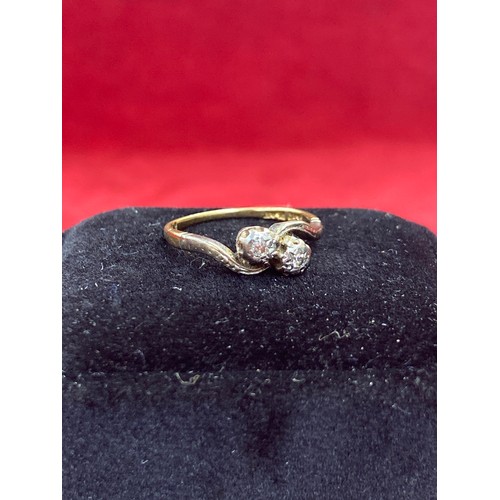 64 - A Vintage 18ct gold ring in crossover design platinum setting with two diamonds. Size L 2.2 grams