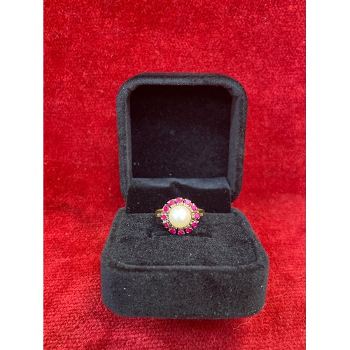 65 - A beautiful vintage 9ct gold dress ring set with a large pearl surrounded by 12 rubies. London hallm... 