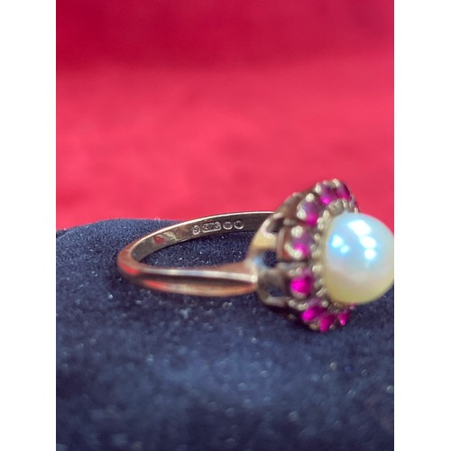 65 - A beautiful vintage 9ct gold dress ring set with a large pearl surrounded by 12 rubies. London hallm... 