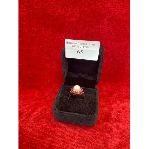 65 - A beautiful vintage 9ct gold dress ring set with a large pearl surrounded by 12 rubies. London hallm... 
