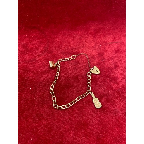 66 - A vintage 9ct gold charm bracelet, London hallmarks, with jug & fiddle charms  - all English hallmar... 