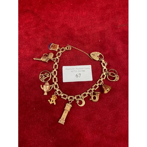 67 - A vintage 9ct gold charm bracelet with square chain links, heart padlock clasp and 10 charms (pistol... 