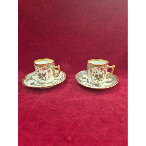 120 - A pair of pretty antique coffee cans and saucers, with hand painted floral and gilt decoration, the ... 