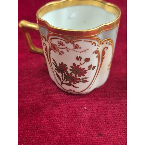 120 - A pair of pretty antique coffee cans and saucers, with hand painted floral and gilt decoration, the ... 