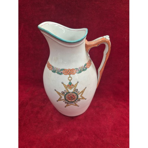 119 - A turn of the century ironstone pottery jug, with polychrome decoration showing the 'Insignia of the... 