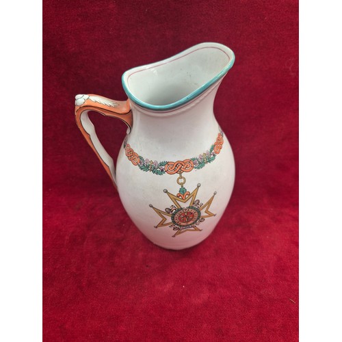 119 - A turn of the century ironstone pottery jug, with polychrome decoration showing the 'Insignia of the... 