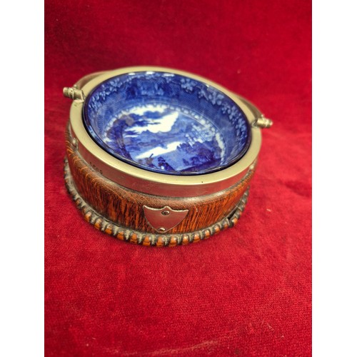 131 - A Victorian flow blue 'Jenny Lind' dish in an oak and E.P.N.S. swing handled table coaster/holder.
T... 