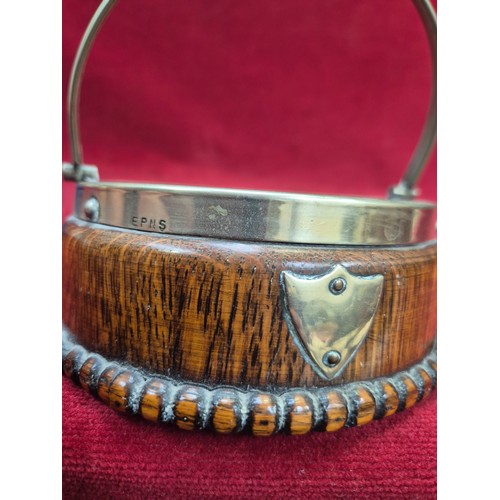 131 - A Victorian flow blue 'Jenny Lind' dish in an oak and E.P.N.S. swing handled table coaster/holder.
T... 