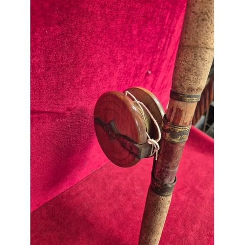156 - Vintage bamboo cane fishing rod, complete with a wooden reel.