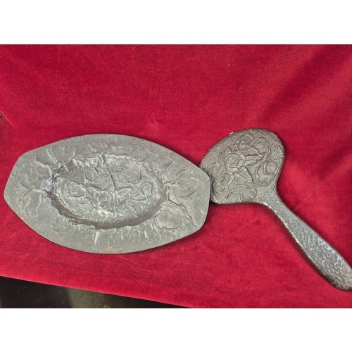 134 - Arts & Crafts pewter dressing table tray and matching hand mirror with embossed floral decoration.