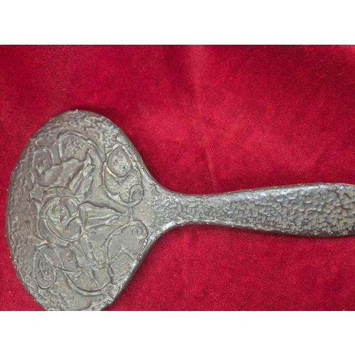 134 - Arts & Crafts pewter dressing table tray and matching hand mirror with embossed floral decoration.