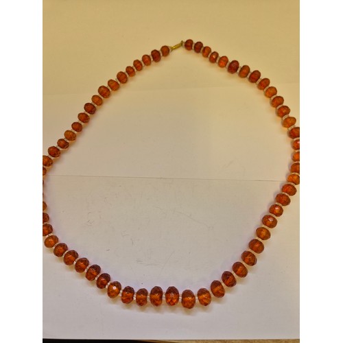 85 - Two circa 1930s faceted amber and glass bead necklaces with barrel clasps. Several of the beads with... 