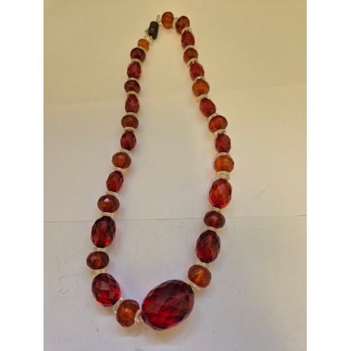 85 - Two circa 1930s faceted amber and glass bead necklaces with barrel clasps. Several of the beads with... 