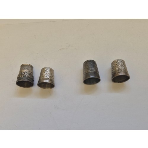 84 - 4 Sterling silver thimbles, all with Birmingham Hallmarks, one with Irish Shamrock and Harp detail a... 