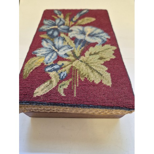 94G - A small wooden box with a needlepoint lid, embroidered with blue Lillies on a red ground.