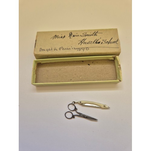 94 - A sweet pair of miniature Victorian scissors, together with a miniature folding cutthroat razor, in ... 