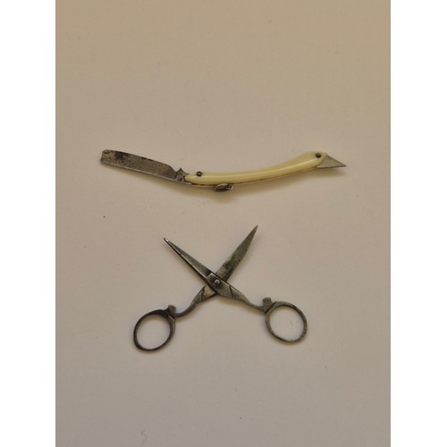 94 - A sweet pair of miniature Victorian scissors, together with a miniature folding cutthroat razor, in ... 