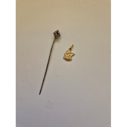 92 - A 375 (9ct) gold pendant charm of a cherub resting his chin on his palm, together with a diamond sha... 