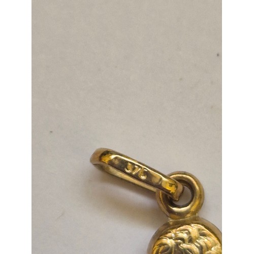 92 - A 375 (9ct) gold pendant charm of a cherub resting his chin on his palm, together with a diamond sha... 