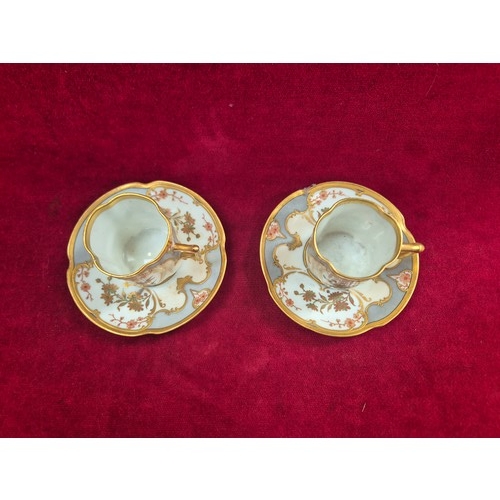 120 - A pair of pretty antique coffee cans and saucers, with hand painted floral and gilt decoration, the ... 