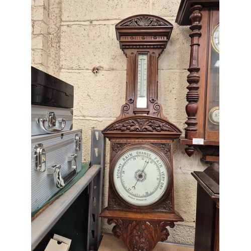 105 - Victorian solid oak banjo wall barometer carved with foliate details, with porcelain dial, brass bez... 
